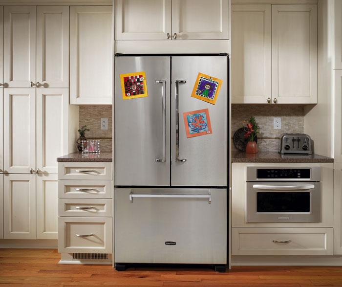 Off white cabinets in casual kitchen by Kitchen Craft Cabinetry