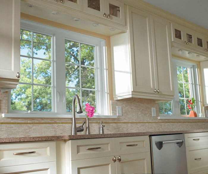 Off white cabinets in casual kitchen by Kitchen Craft Cabinetry