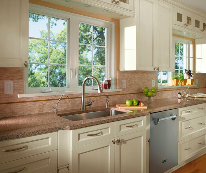 Off white cabinets in casual kitchen by Kitchen Craft Cabinetry