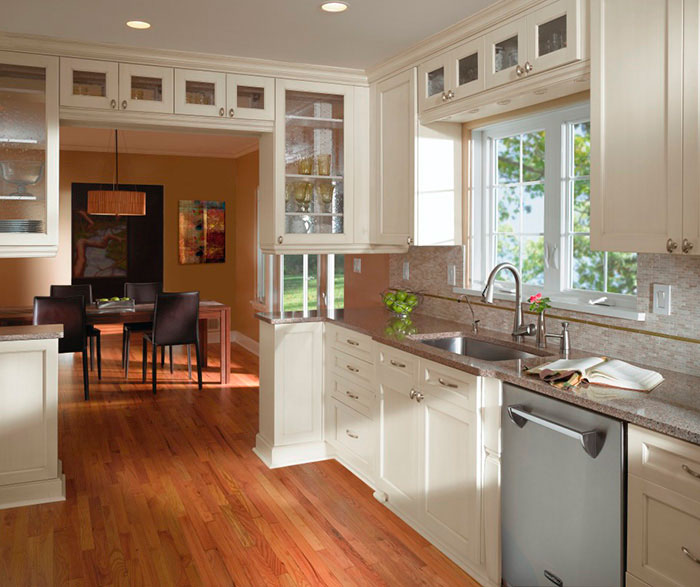 Off white cabinets in casual kitchen by Kitchen Craft Cabinetry